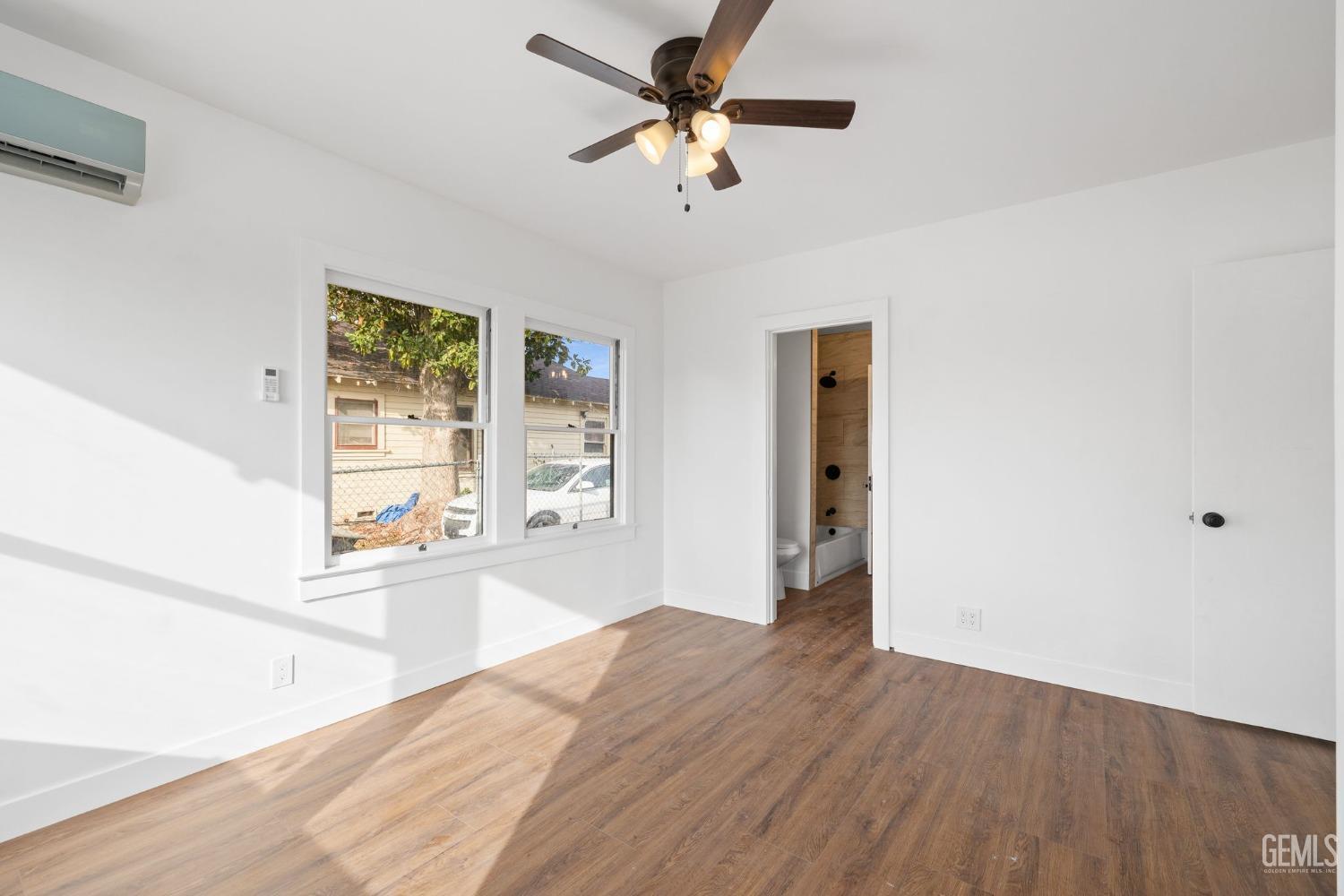 Undisclosed Address Bakersfield, CA 93308 - Photo 11 of 21 a view of a livingroom with wooden floor and a ceiling fan