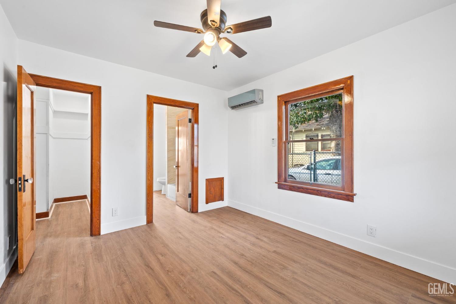 Undisclosed Address Bakersfield, CA 93308 - Photo 13 of 21 a view of an empty room with a window and wooden floor