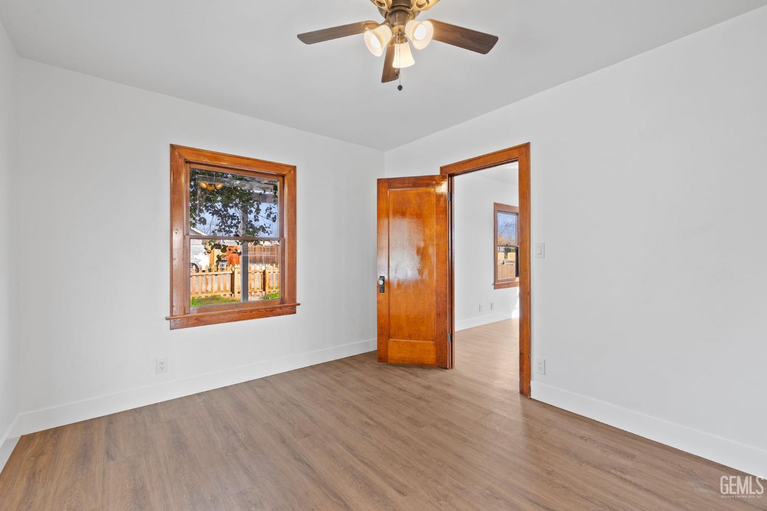 Undisclosed Address Bakersfield, CA 93308 - Photo 14 of 21 a view of an empty room with wooden floor and a window