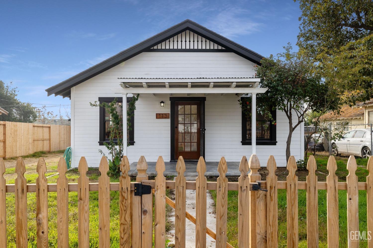 Undisclosed Address Bakersfield, CA 93308 - Photo 2 of 21 a front view of white house with wooden fence