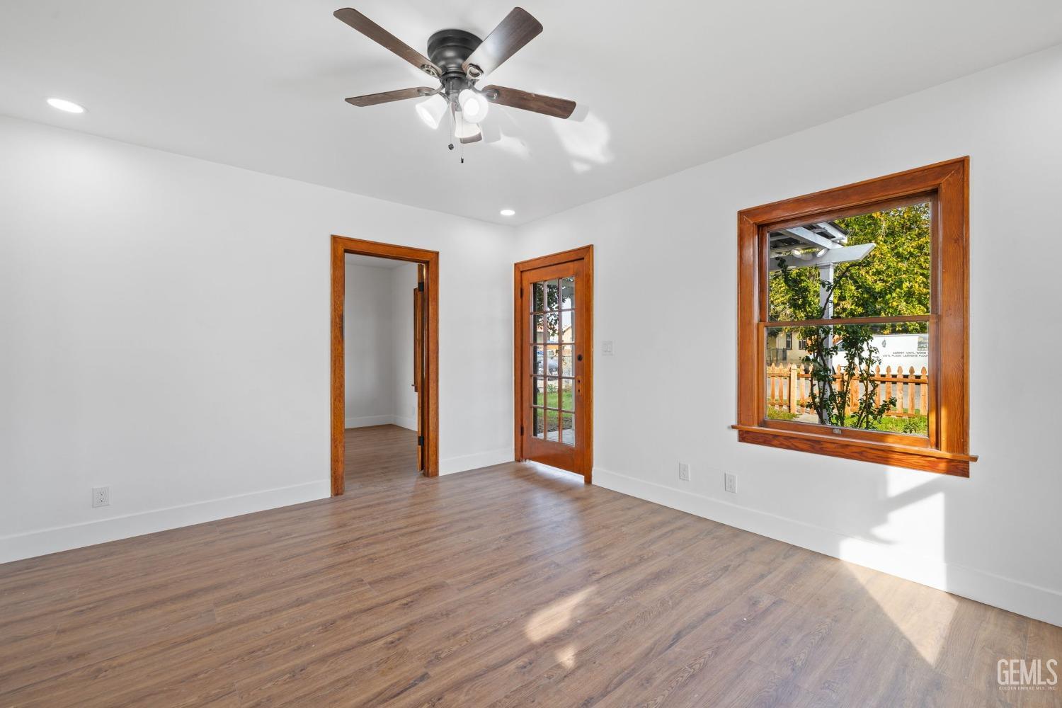 Undisclosed Address Bakersfield, CA 93308 - Photo 4 of 21 a view of an empty room with wooden floor and a window