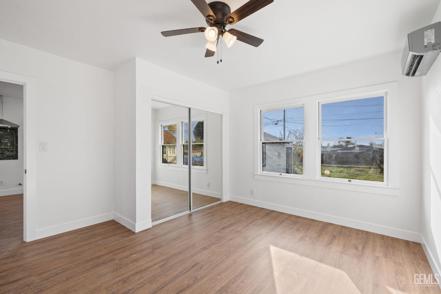 Undisclosed Address Bakersfield, CA 93308 - Photo 10 of 21 a view of an empty room with window and wooden floor