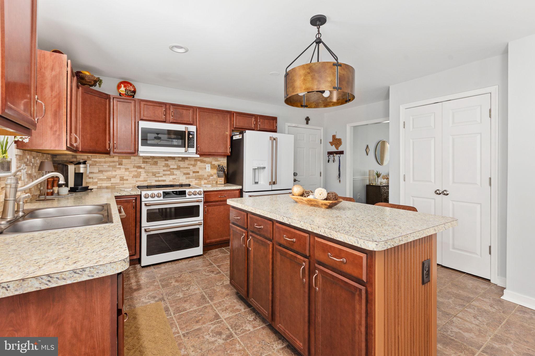 22088 Landora Bridge Road Ruther Glen, VA 22546 - Photo 47 of 122 Modern kitchen with warm wood tones.