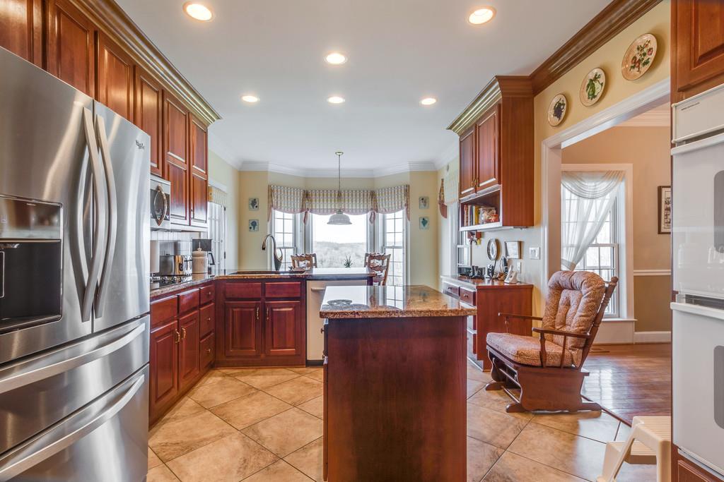 373 Gimlet Road Fayetteville, TN 37334 - Photo 7 of 29 a kitchen with stainless steel appliances granite countertop a refrigerator and a sink
