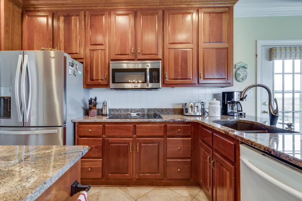 373 Gimlet Road Fayetteville, TN 37334 - Photo 8 of 29 a kitchen with granite countertop a refrigerator stove and microwave
