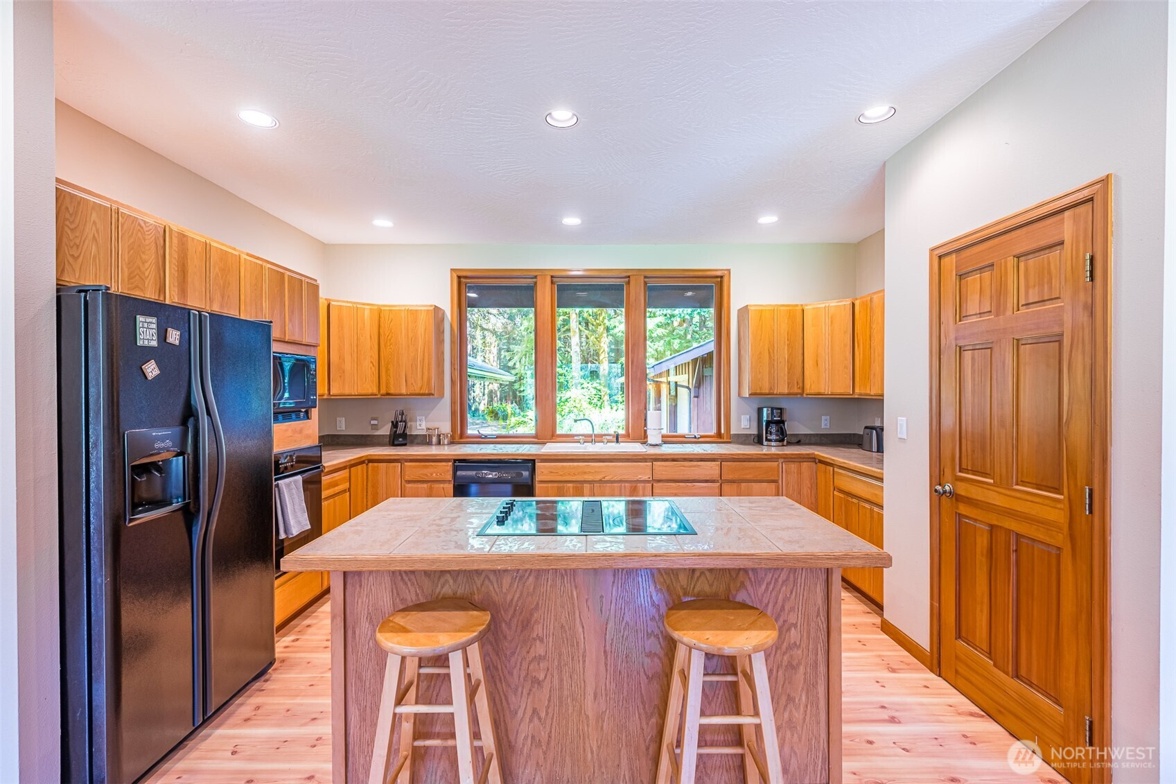 173 Pleasant Meadows Lane Beaver, WA 98305 - Photo 12 of 40 a kitchen with stainless steel appliances granite countertop a refrigerator a sink and wooden cabinets