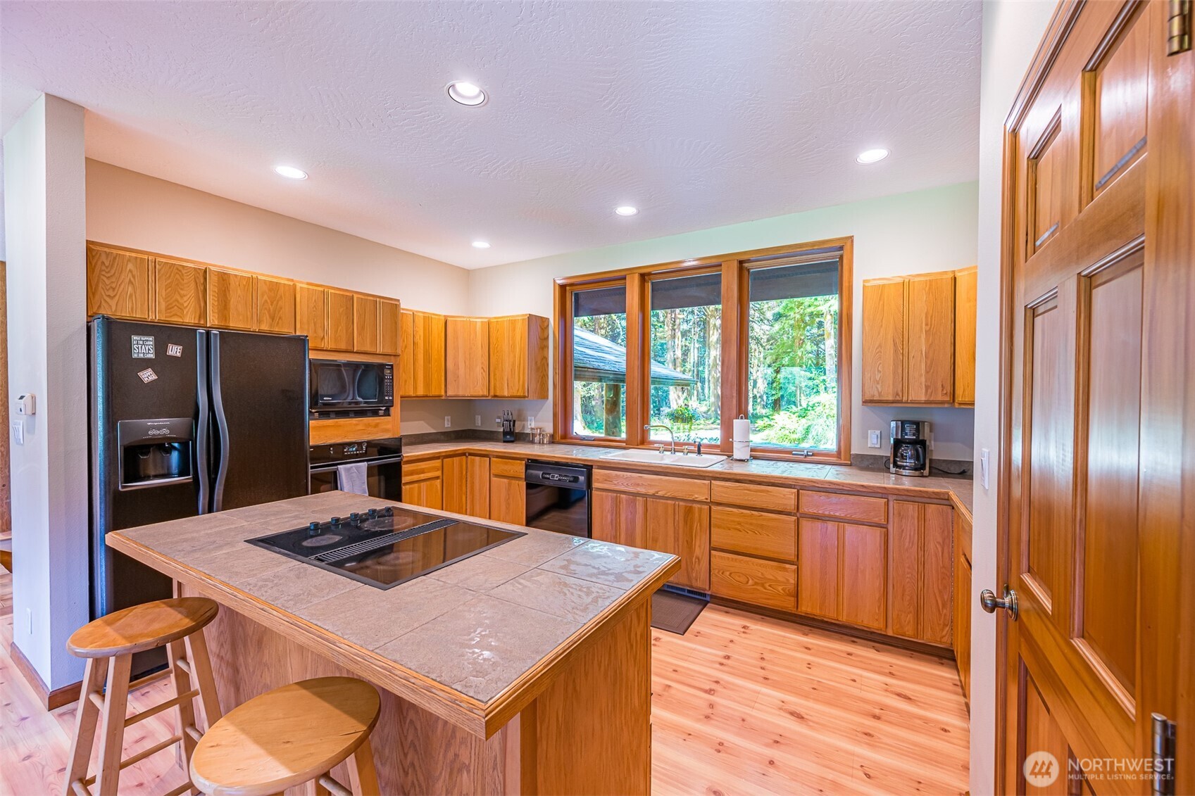 173 Pleasant Meadows Lane Beaver, WA 98305 - Photo 13 of 40 a kitchen with stainless steel appliances granite countertop sink stove refrigerator and cabinets