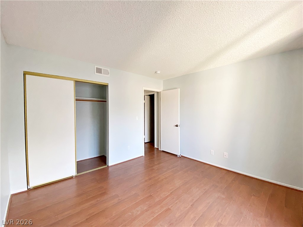 1575 West Warm Springs Road, Unit 1024 Henderson, NV 89014 - Photo 22 of 25 Hardwood floors and a spacious closet create a clean, versatile private space.