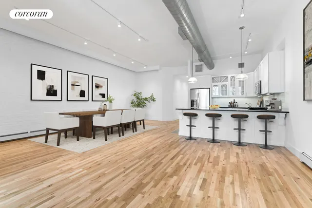 a kitchen with stainless steel appliances kitchen island a refrigerator and a stove top oven