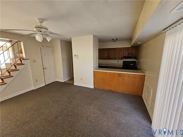 a kitchen with granite countertop a stove sink and refrigerator