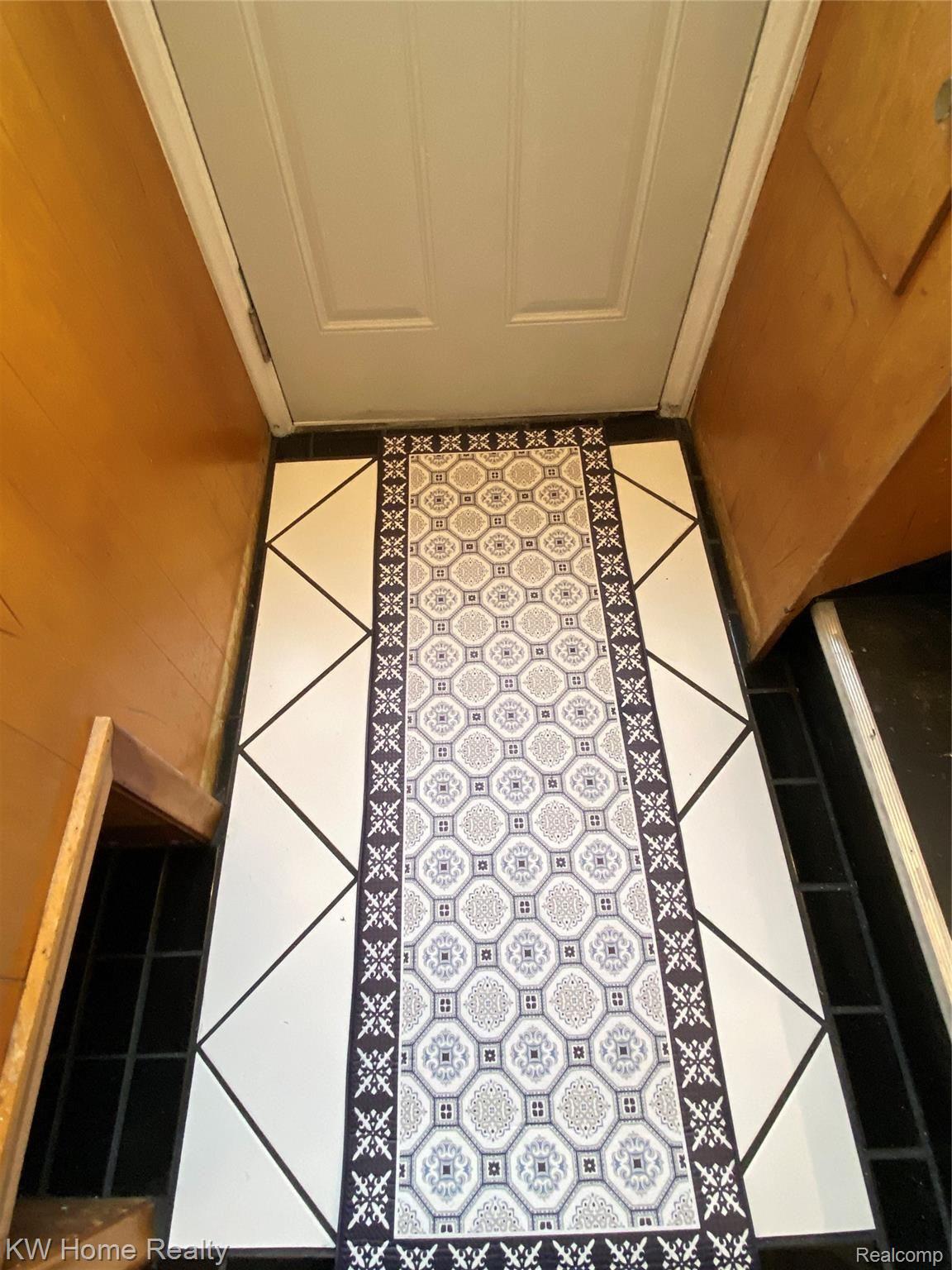 11304 Inkster Road Redford, MI 48239 - Photo 57 of 62 Peak at the newly tiled side landing with cubby to left for shoes.