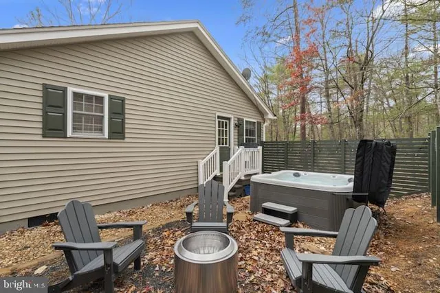 a view of a patio with table and chairs and barbeque