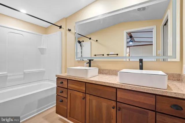 a kitchen with a sink and a mirror