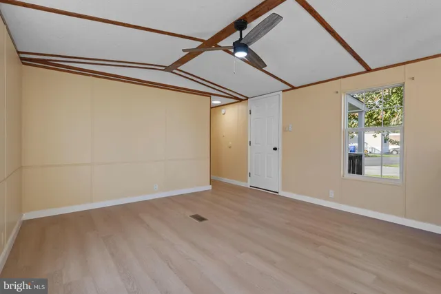 a view of a room with wooden floor and windows