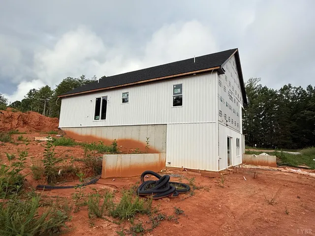 a backyard of a house with lots of green space and outdoor seating