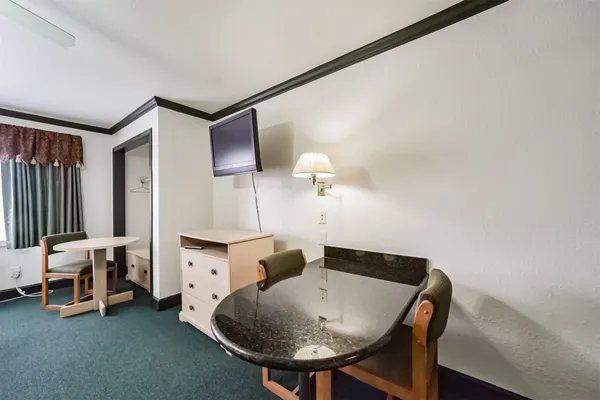 a living room with furniture and a dresser