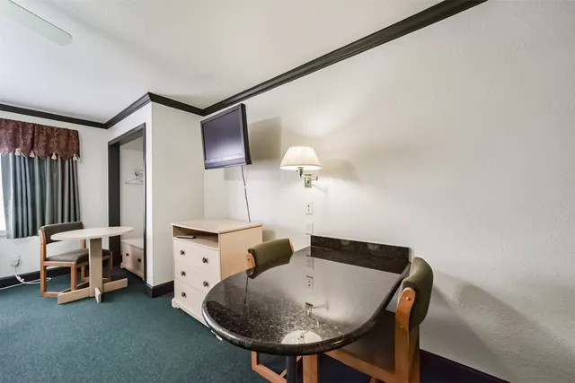 a living room with furniture and a dresser