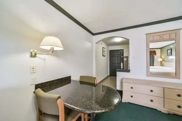a bathroom with a granite countertop sink toilet and shower