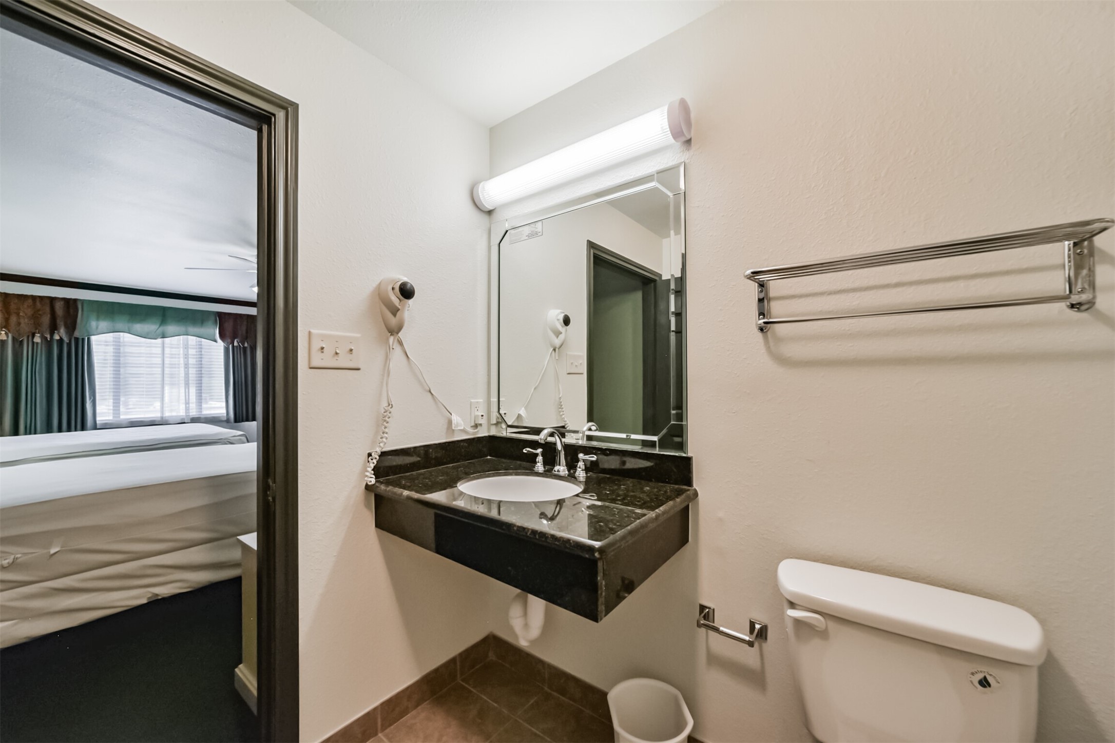 1025 Swanson Street, Unit 309 Houston, TX 77030 - Photo 17 of 21 a bathroom with a sink a toilet and a mirror