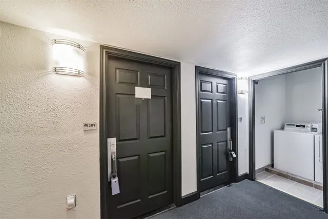 a view of hallway with bathroom