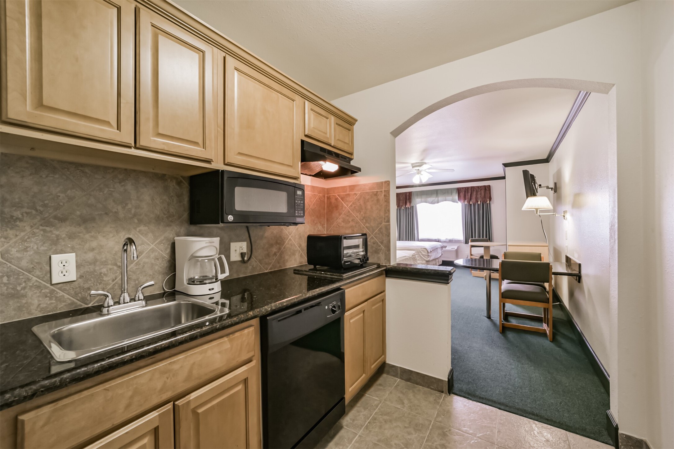 1025 Swanson Street, Unit 309 Houston, TX 77030 - Photo 7 of 21 a kitchen with granite countertop a sink dishwasher stove and cabinets