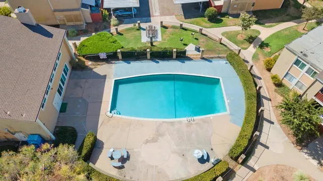 an aerial view of a house with a swimming pool and outdoor space