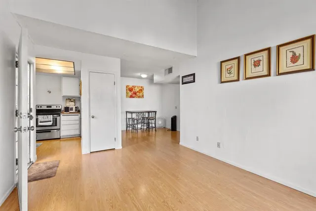 a view of empty room with wooden floor