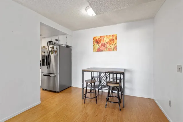 a view of a kitchen with furniture and wooden floor