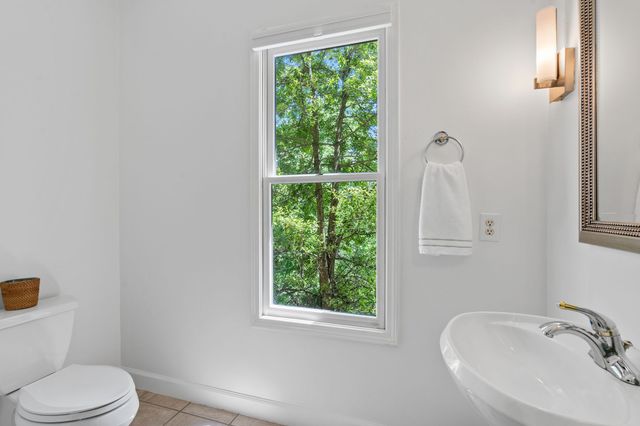 a white toilet sitting next to a bathroom sink
