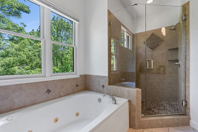 a bathroom with a tub a sink and shower