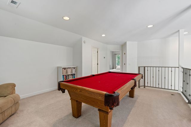 a living room with a table and pool table