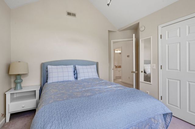 a bedroom with a bed and a lamp