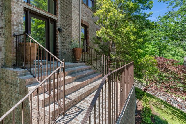 a view of balcony with wooden floor and fence