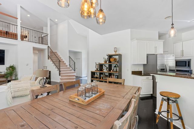 a living room with furniture and kitchen view
