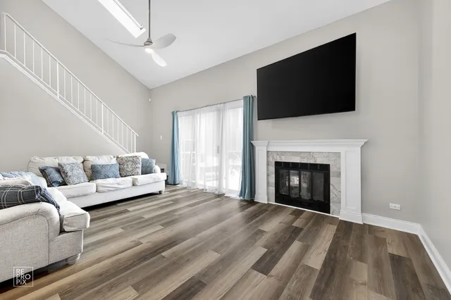 a living room with a fireplace furniture and a flat screen tv