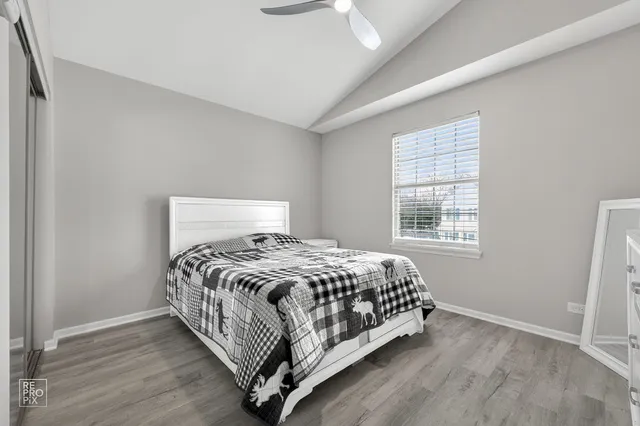 a bed sitting in a bedroom next to a window