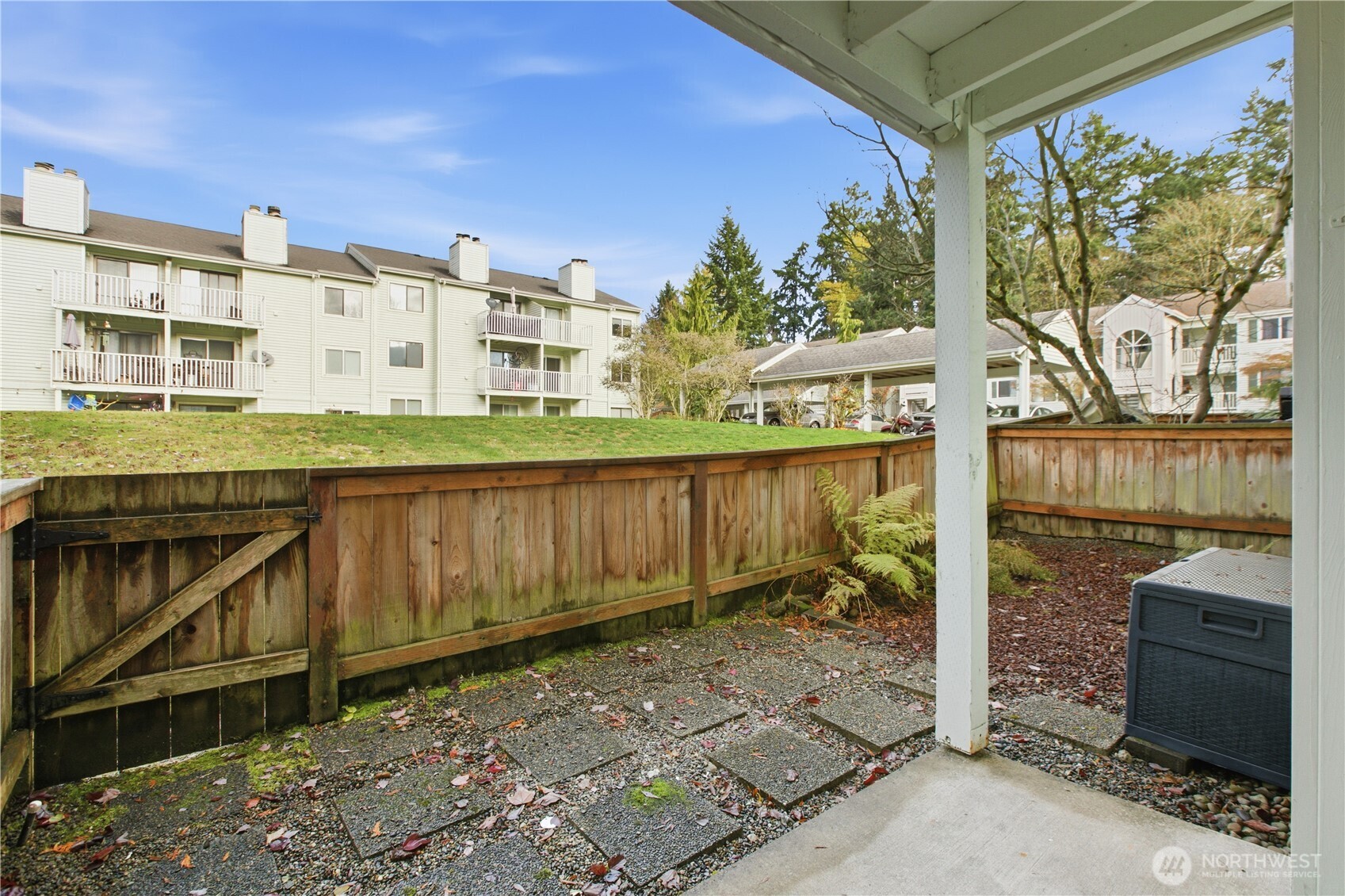 25035 98th Place South, Unit D102 Kent, WA 98030 - Photo 20 of 28 a view of a balcony with wooden floor and fence