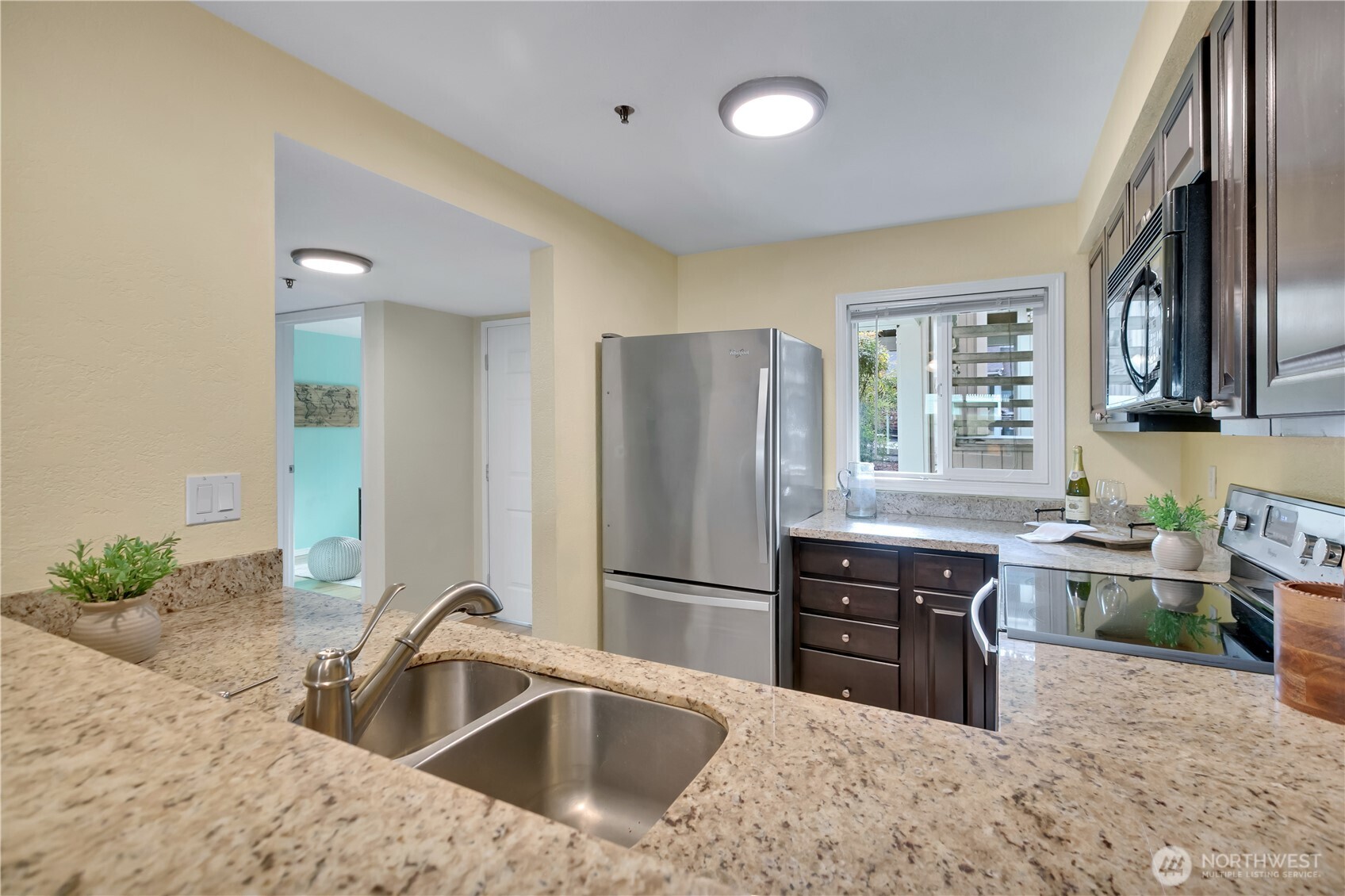 25035 98th Place South, Unit D102 Kent, WA 98030 - Photo 6 of 28 a kitchen with stainless steel appliances granite countertop a sink stove and refrigerator