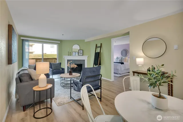 a living room with furniture a fireplace and potted plants