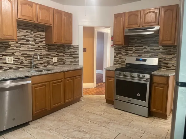 a kitchen with stainless steel appliances granite countertop a stove and cabinets