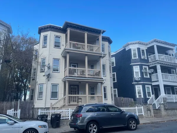 a front view of a residential apartment building with a yard