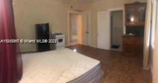 2007 North Bay Road, Unit STUDIO2 Miami Beach, FL 33140 - Photo 3 of 4 a living room with a wooden floor