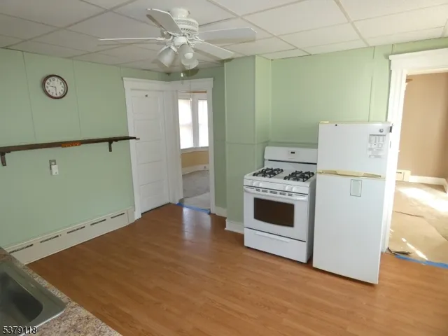 a kitchen with a refrigerator and a stove top oven