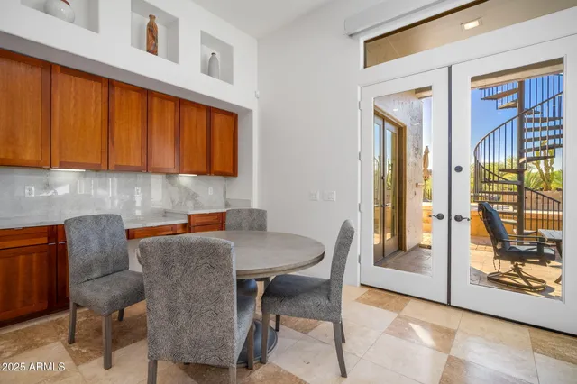 a bedroom with furniture and a large window
