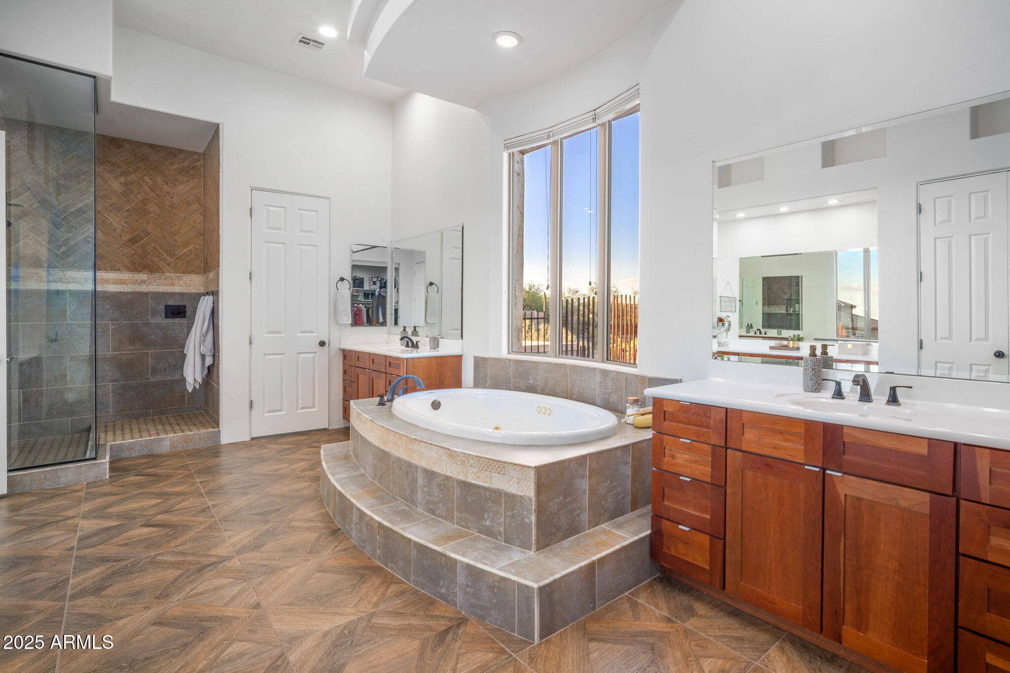 10302 South 16th Avenue Phoenix, AZ 85041 - Photo 46 of 74 a spacious bathroom with a double vanity sink a mirror and a bathtub