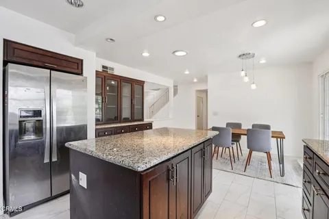 an open kitchen with a table and chairs