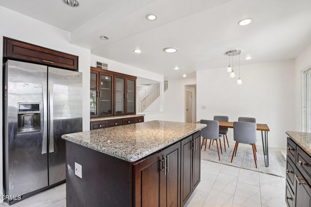 10856 Topeka Drive Porter Ranch, CA 91326 - Photo 9 of 40 an open kitchen with a table and chairs