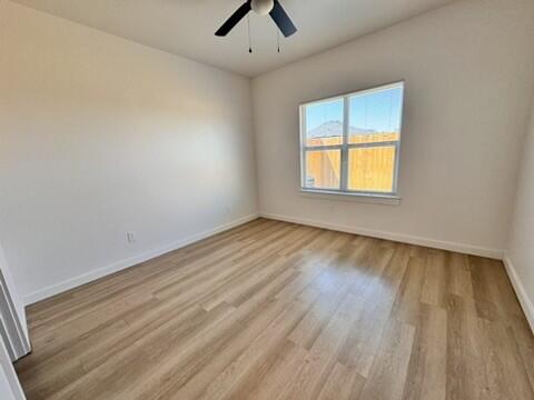 5711 Kemper Street, Unit B Lubbock, TX 79416 - Photo 11 of 20 wooden floor in an empty room with a window