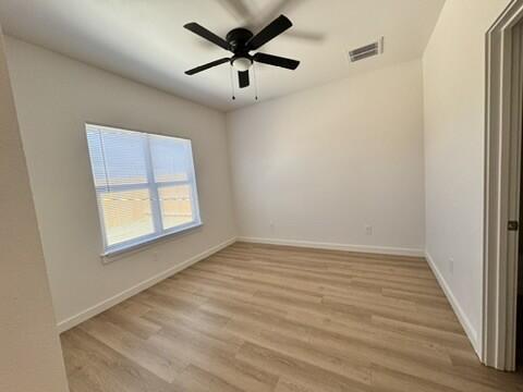 5711 Kemper Street, Unit B Lubbock, TX 79416 - Photo 14 of 20 an empty room with a window and a fan