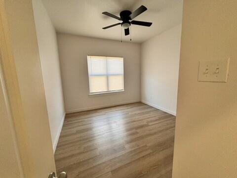 5711 Kemper Street, Unit B Lubbock, TX 79416 - Photo 15 of 20 a view of empty room with wooden floor and fan
